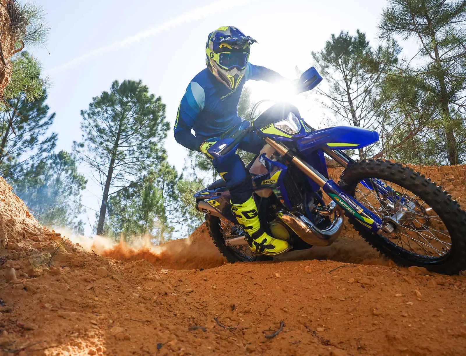 Sherco enduro rider in a dusty corner
