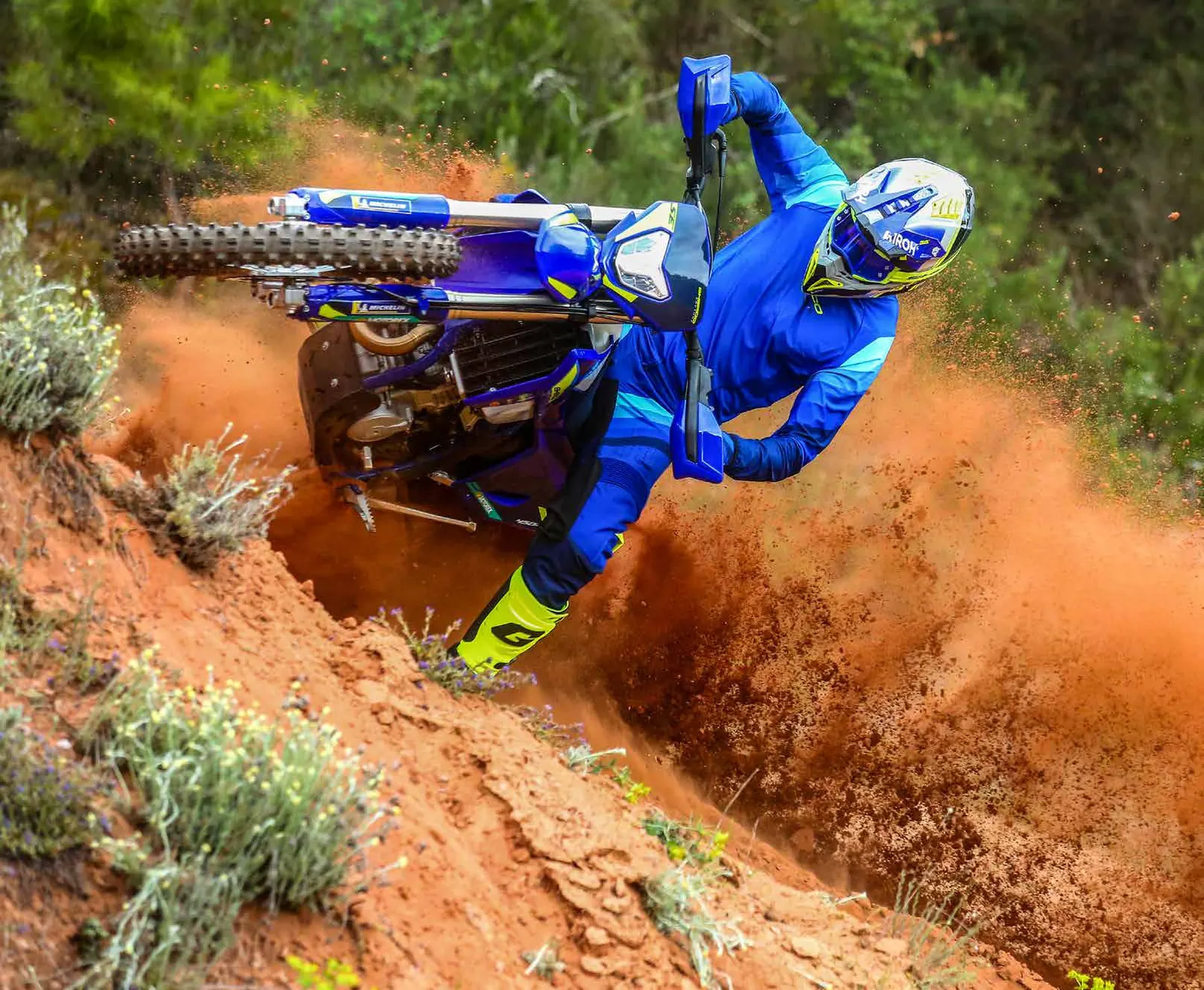 Sherco enduro rider on a red dirt trail